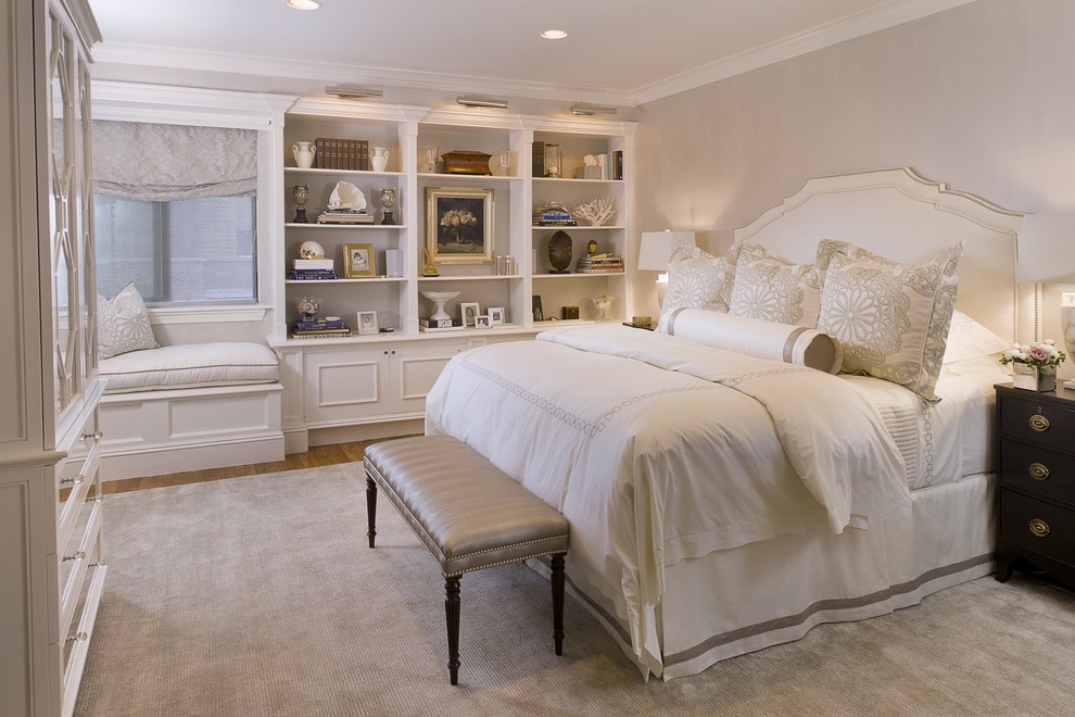 Photo of a large traditional master bedroom in New York with no fireplace, medium hardwood floors and grey walls.
