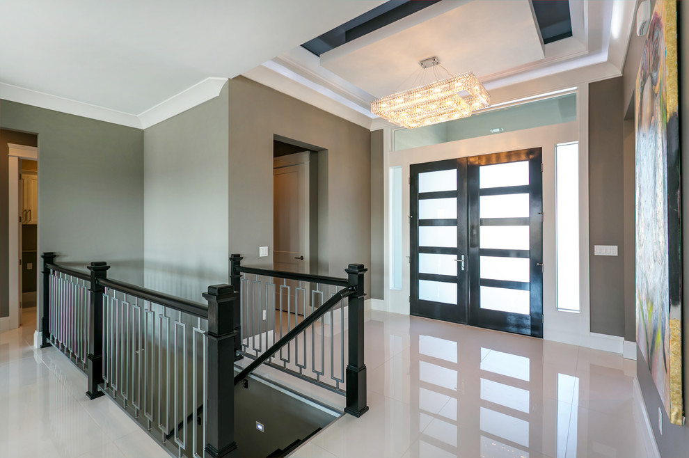 Example of a mid-sized trendy white floor foyer design in Seattle with gray walls and a black front door