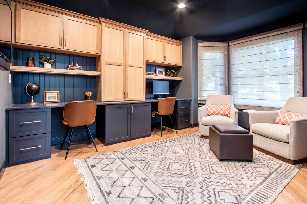 Traditional home office in Denver with grey walls, medium hardwood flooring, a built-in desk and brown floors.