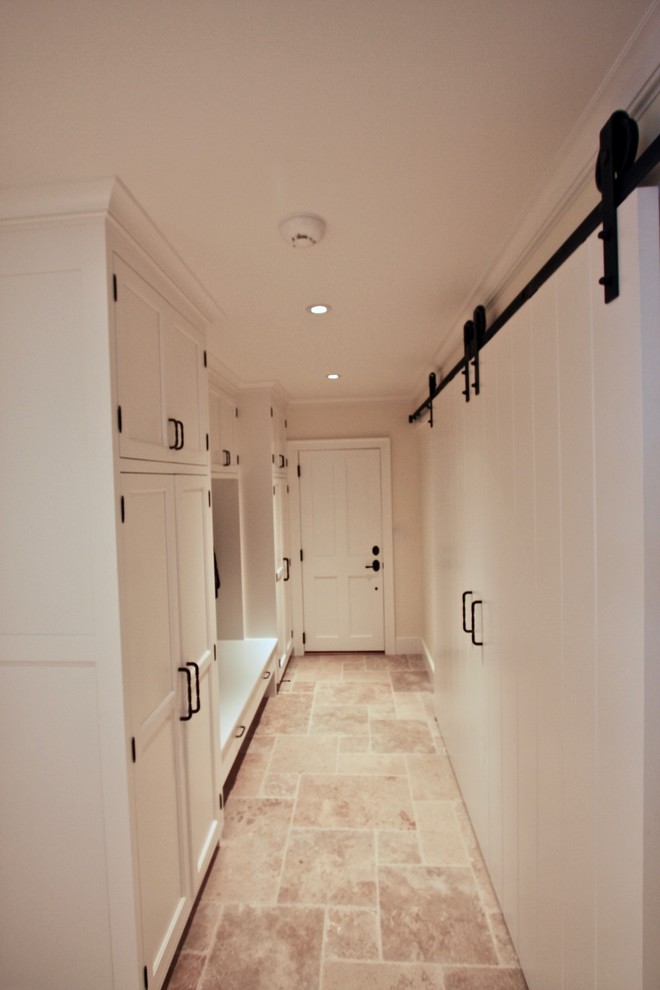 Design ideas for a mid-sized traditional mudroom in New York with yellow walls, travertine floors, a single front door, a white front door and beige floor.