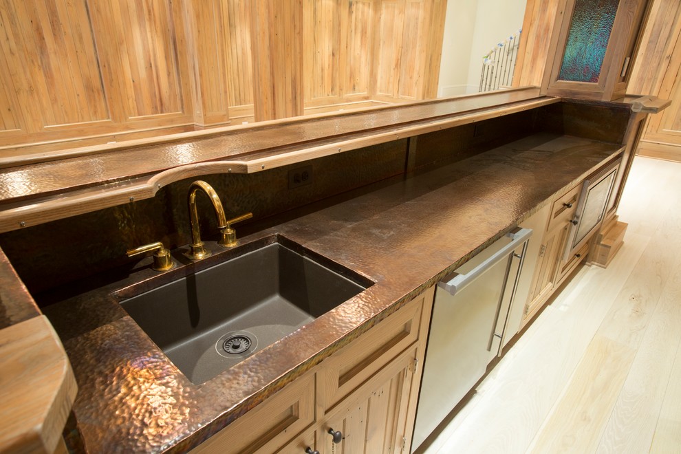 Design ideas for a galley seated home bar in DC Metro with an undermount sink, copper benchtops and timber splashback.