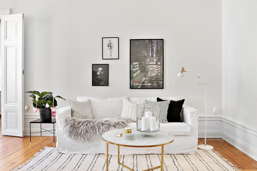 Modern enclosed living room in Stockholm with white walls, medium hardwood floors and orange floor.