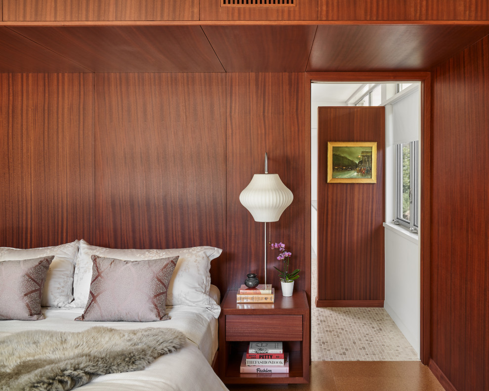Inspiration for a mid-sized midcentury master bedroom in Austin with brown walls, cork floors, no fireplace, brown floor, wood and wood walls.