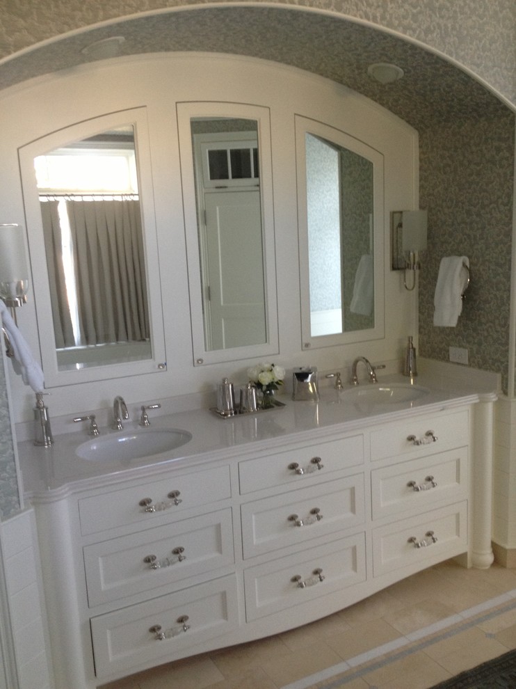 This is an example of a traditional master bathroom in Phoenix with furniture-like cabinets, white cabinets, an undermount sink and marble benchtops.