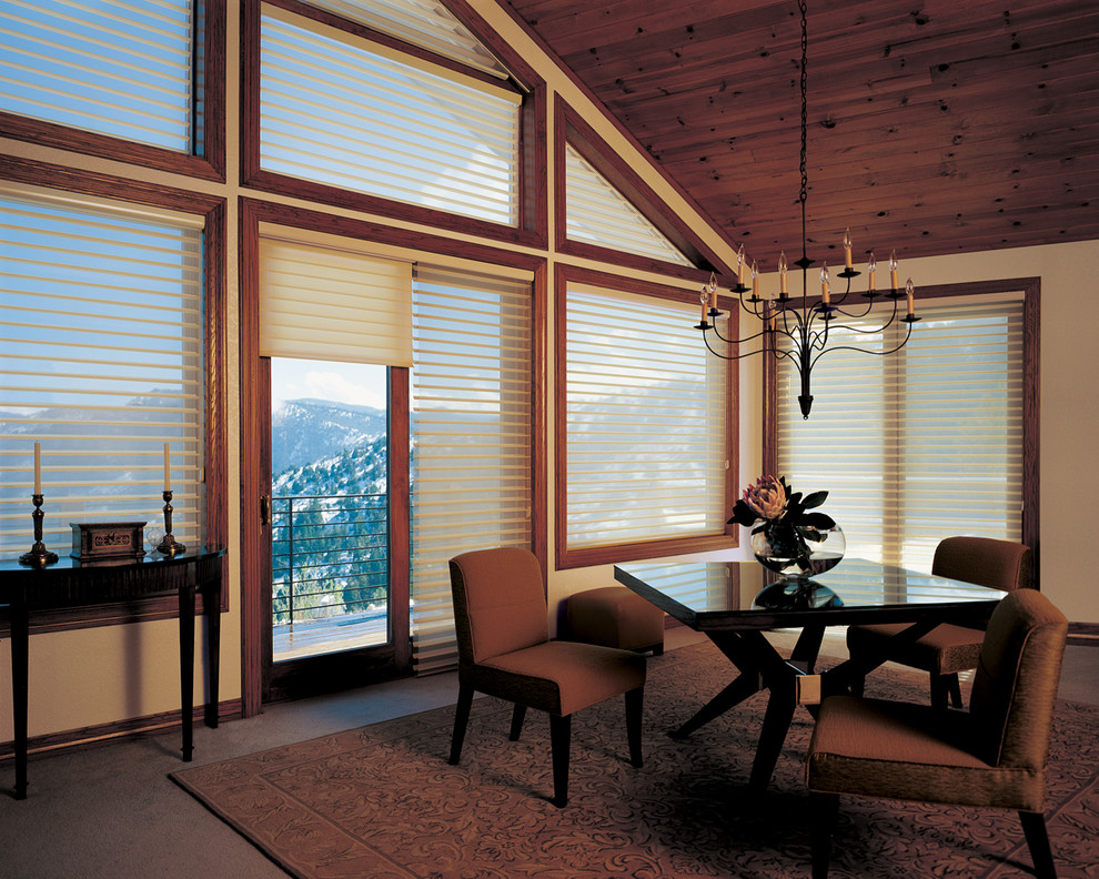 Example of a mid-sized mountain style carpeted great room design with beige walls and no fireplace