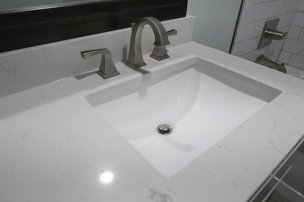 Mid-sized transitional kids' white tile and porcelain tile porcelain tile and gray floor alcove bathtub photo with shaker cabinets, gray cabinets, a two-piece toilet, green walls, an undermount sink, quartz countertops and white countertops