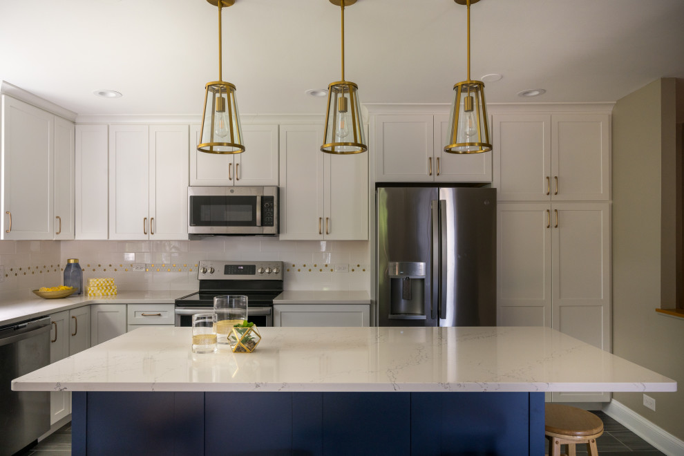 Open concept kitchen - large transitional u-shaped porcelain tile and gray floor open concept kitchen idea in Chicago with an undermount sink, shaker cabinets, white cabinets, quartz countertops, white backsplash, ceramic backsplash, stainless steel appliances, an island and white countertops