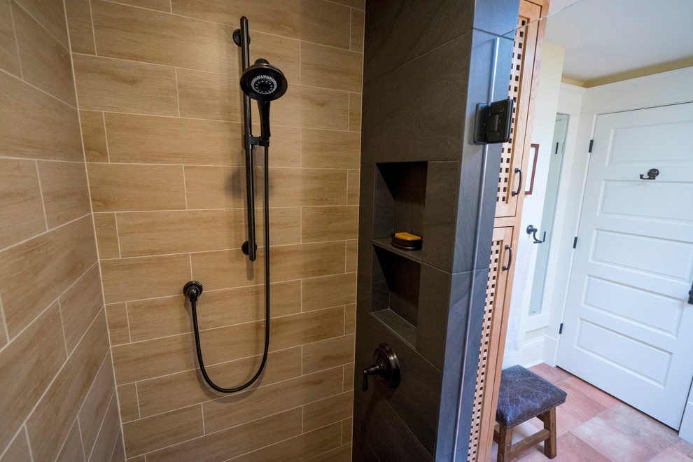 Photo of a mid-sized contemporary 3/4 bathroom in Seattle with shaker cabinets, medium wood cabinets, a corner shower, a two-piece toilet, black tile, porcelain tile, yellow walls, porcelain floors, a pedestal sink and tile benchtops.