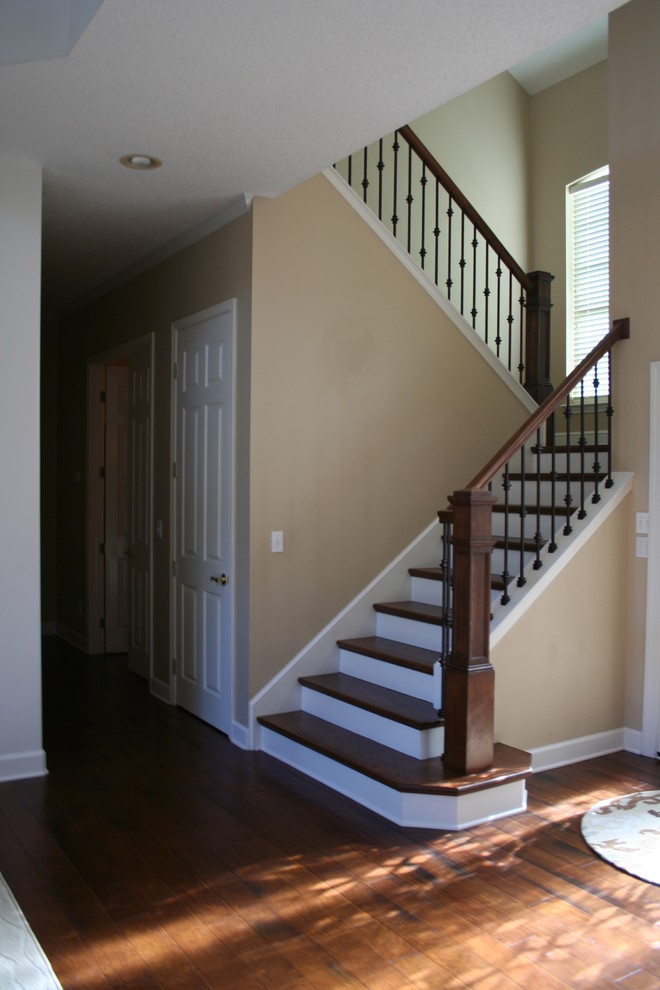 Example of a mid-sized transitional medium tone wood floor entry hall design in Jacksonville with beige walls and a glass front door