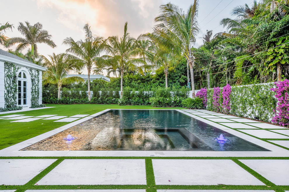 Mid-sized contemporary backyard rectangular lap pool in Miami with a hot tub.