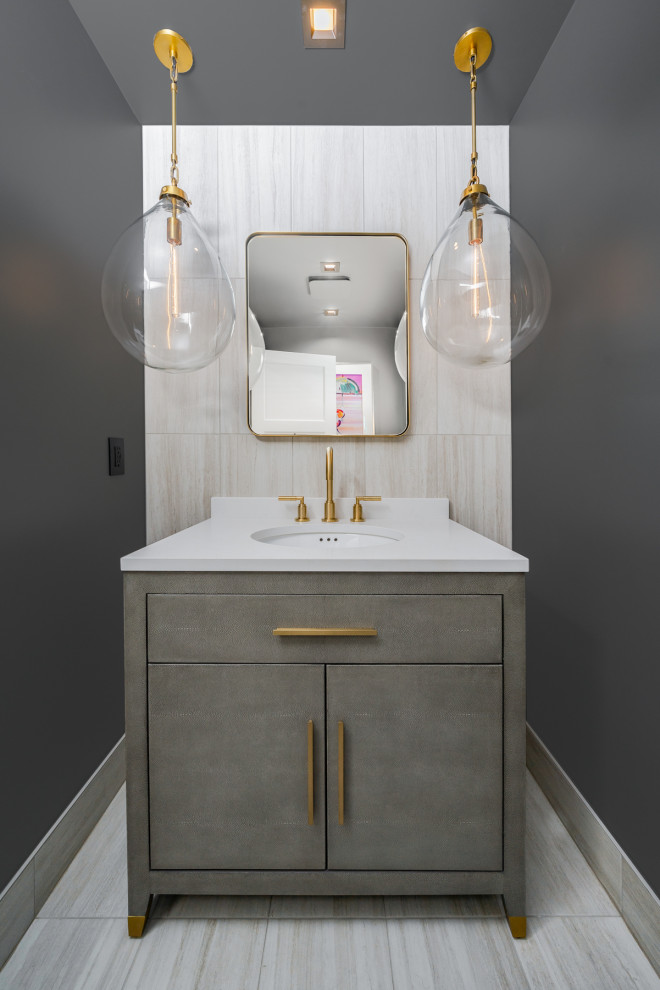 Inspiration for a small modern beige tile and ceramic tile porcelain tile and white floor powder room remodel in San Diego with flat-panel cabinets, gray cabinets, a two-piece toilet, beige walls, an undermount sink, quartz countertops, white countertops and a freestanding vanity