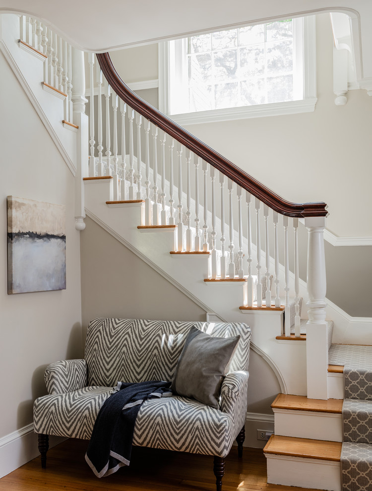 Photo of a transitional wood l-shaped staircase in Boston with wood risers and wood railing.