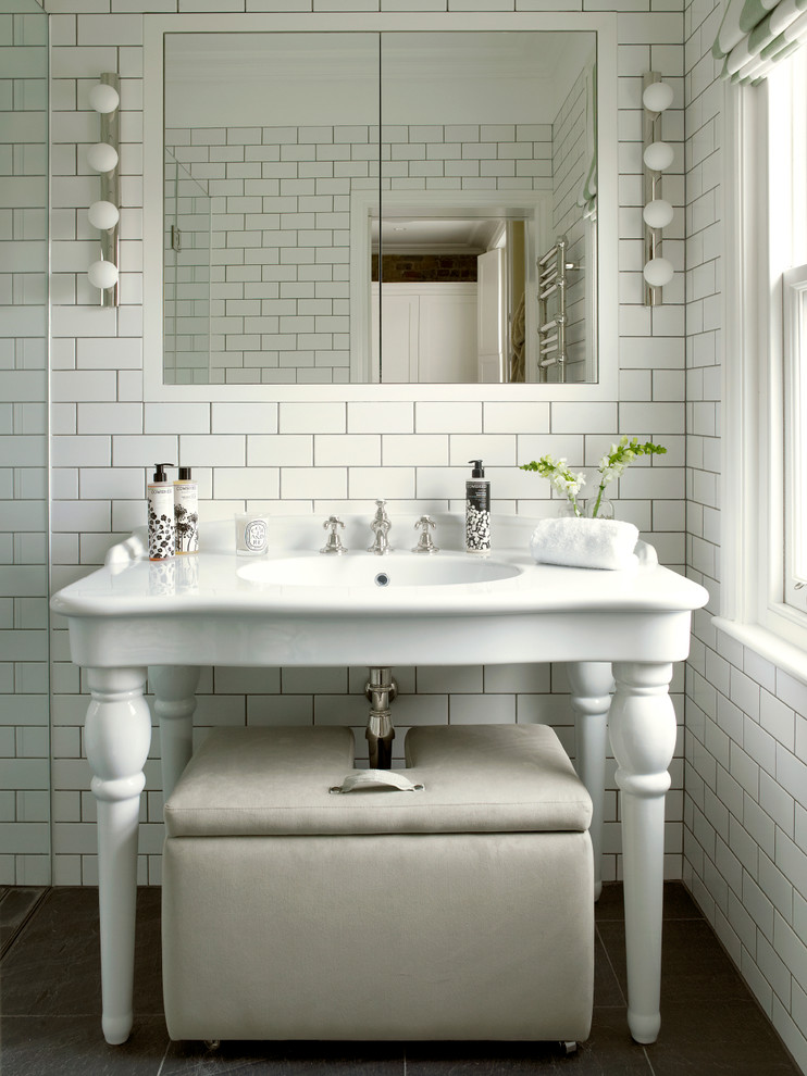 Mid-sized traditional master bathroom in London with a console sink, white tile, subway tile, flat-panel cabinets, white cabinets, an open shower, a wall-mount toilet, white walls, slate floors, grey floor and a hinged shower door.