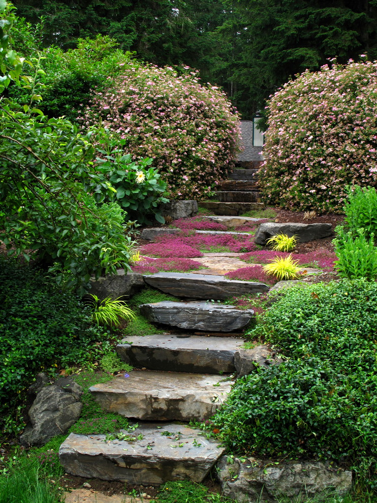 Photo of a traditional sloped garden in Seattle.