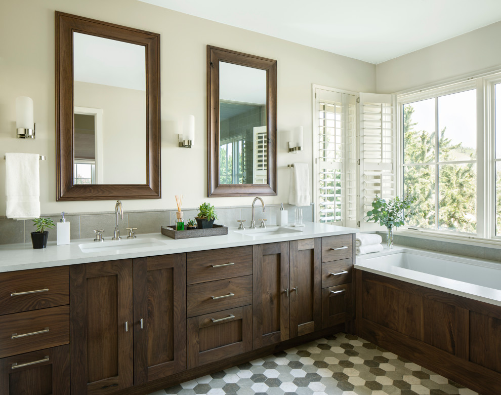 Large country master bathroom in Denver with shaker cabinets, brown cabinets, a drop-in tub, white walls, an undermount sink, grey floor, white benchtops, a double vanity and a built-in vanity.