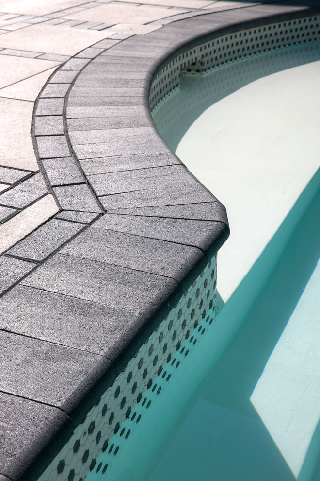 Mid-sized transitional backyard pool photo