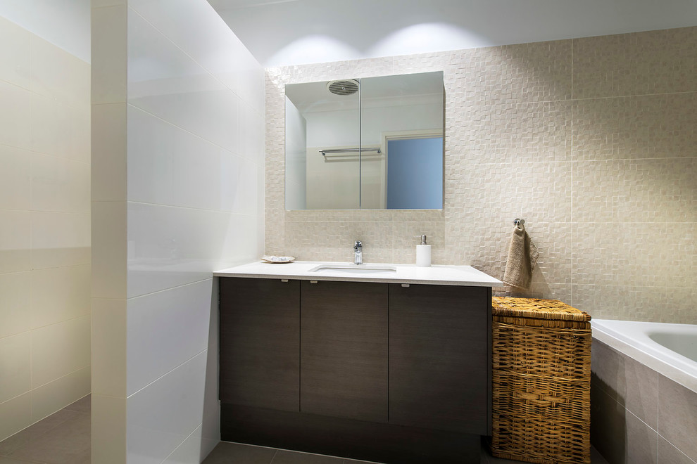 Small contemporary bathroom in Perth with a drop-in sink, flat-panel cabinets, dark wood cabinets, a corner tub, an alcove shower, brown tile, ceramic tile, beige walls and ceramic floors.