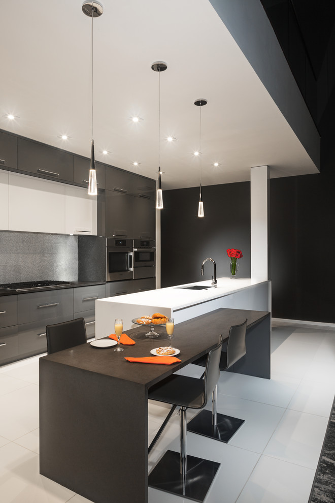 This is an example of a large contemporary galley eat-in kitchen in Atlanta with a single-bowl sink, flat-panel cabinets, grey cabinets, quartz benchtops, grey splashback, metal splashback, stainless steel appliances, porcelain floors, with island, white floor and grey benchtop.