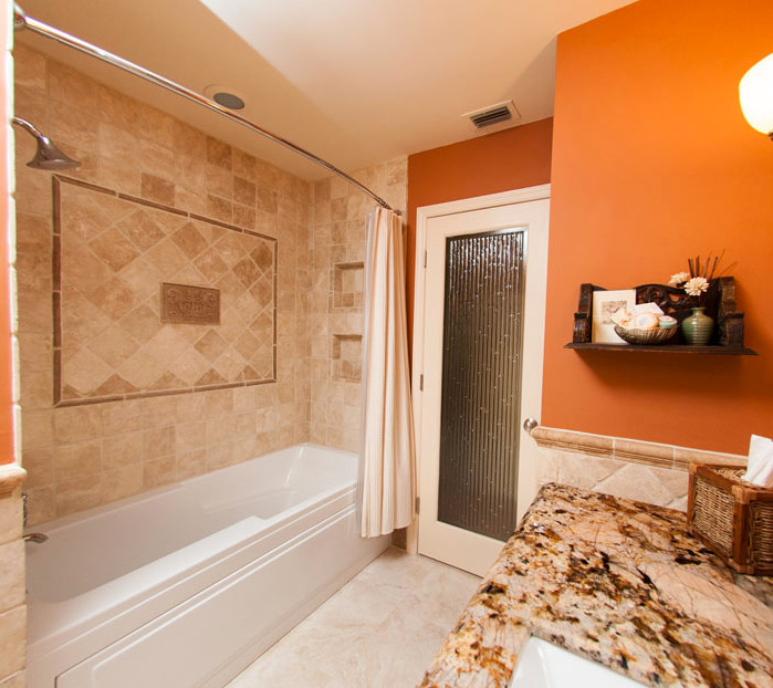 Example of a mid-sized transitional master beige tile and ceramic tile ceramic tile alcove bathtub design in Miami with furniture-like cabinets, medium tone wood cabinets, orange walls, an undermount sink and granite countertops