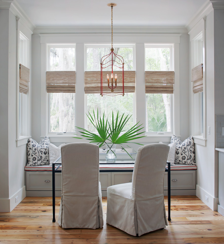 Inspiration for a beach style dining room in Atlanta with grey walls, medium hardwood floors and brown floor.