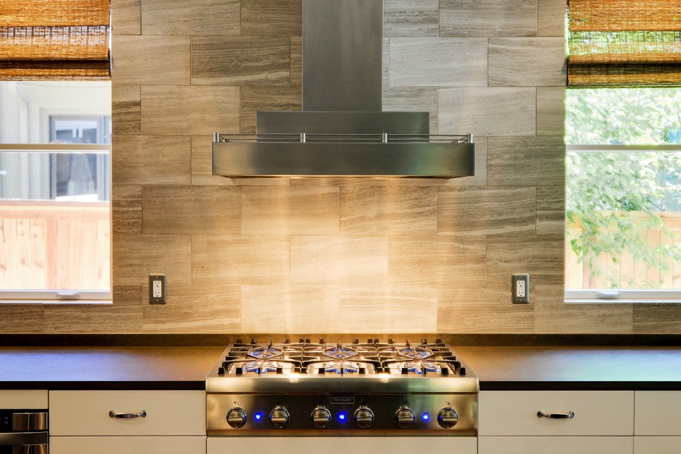 Example of a mid-sized transitional l-shaped medium tone wood floor open concept kitchen design in Denver with shaker cabinets, white cabinets, gray backsplash, paneled appliances and an island