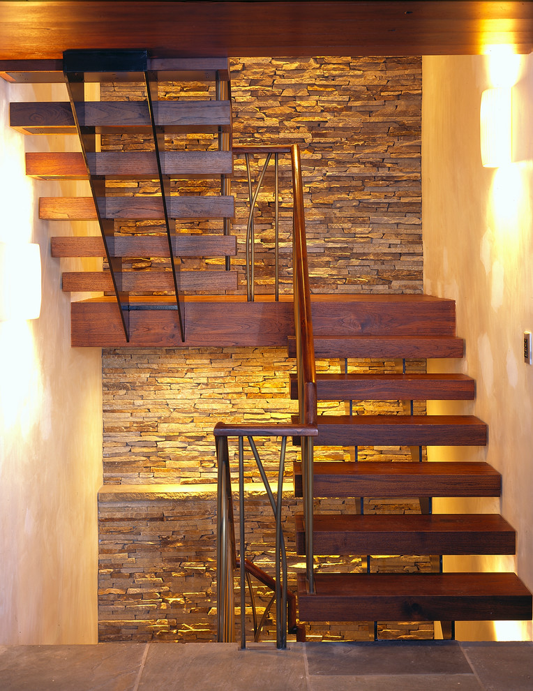 Inspiration for a contemporary wood u-shaped staircase in Boston with open risers and metal railing.