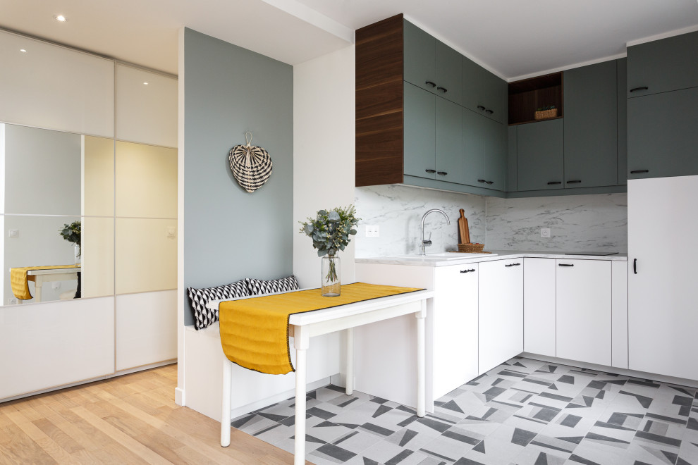 Small scandinavian l-shaped open plan kitchen in Paris with a single-bowl sink, flat-panel cabinets, laminate benchtops, white splashback, panelled appliances, ceramic floors, no island and grey floor.