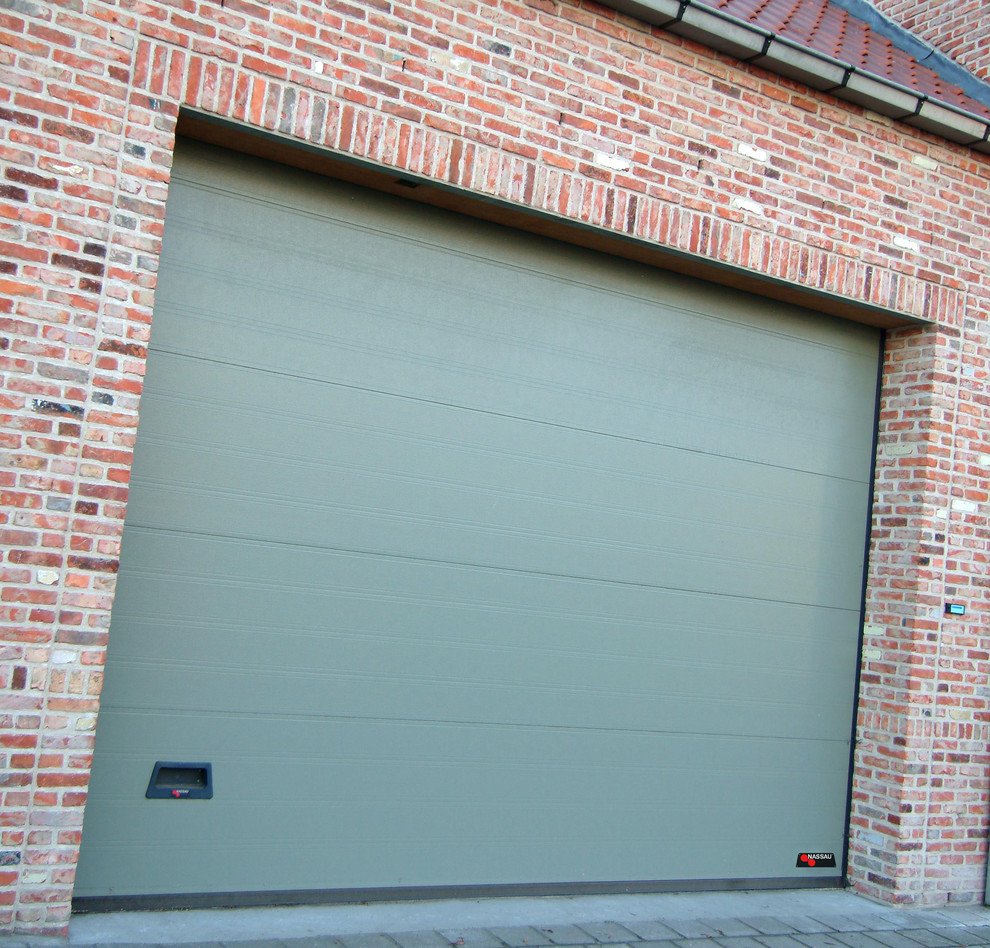 This is an example of a large scandinavian attached one-car garage in Odense.