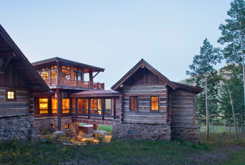 Country three-storey exterior in Denver with wood siding.