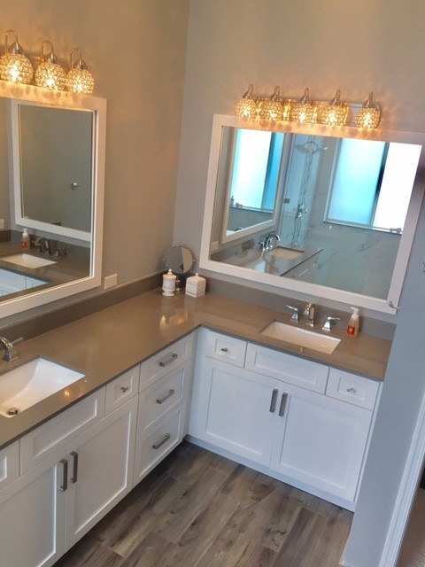 This is an example of a large transitional master bathroom in Miami with shaker cabinets, white cabinets, an open shower, a two-piece toilet, gray tile, white tile, porcelain tile, grey walls, dark hardwood floors, an undermount sink, solid surface benchtops, brown floor and an open shower.
