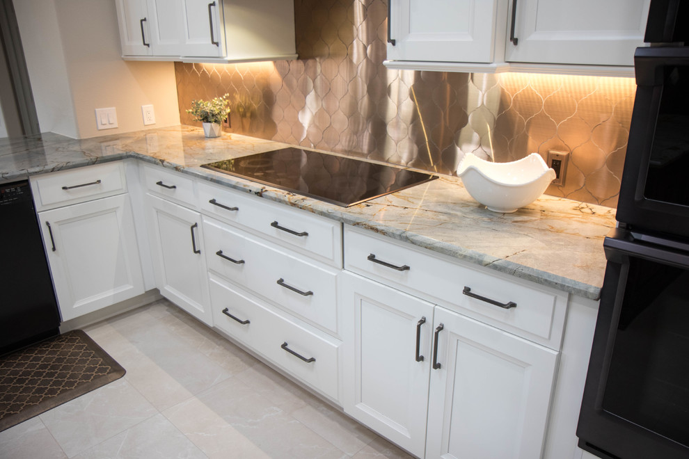 Design ideas for a large transitional u-shaped open plan kitchen in Orlando with an undermount sink, recessed-panel cabinets, white cabinets, granite benchtops, metallic splashback, metal splashback, black appliances, porcelain floors, with island, beige floor and grey benchtop.