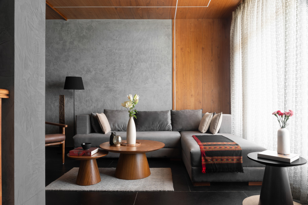 Contemporary living room in Other with grey walls, black floor, wood and wood walls.