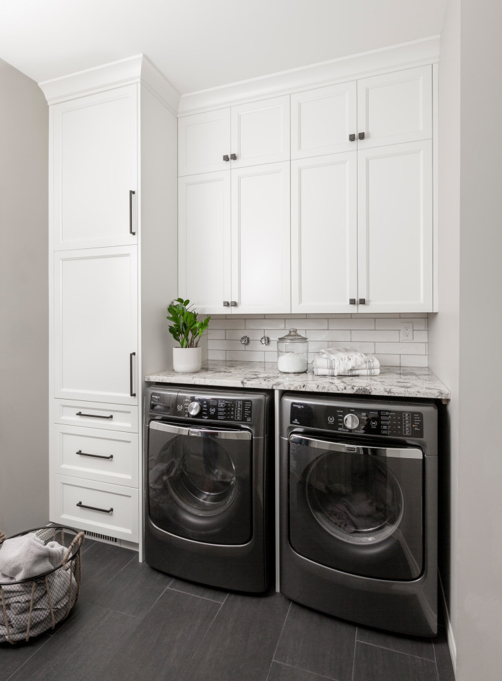 Inspiration for a transitional l-shaped ceramic tile and gray floor utility room remodel in Calgary with shaker cabinets, white cabinets, granite countertops, gray walls, a side-by-side washer/dryer and gray countertops