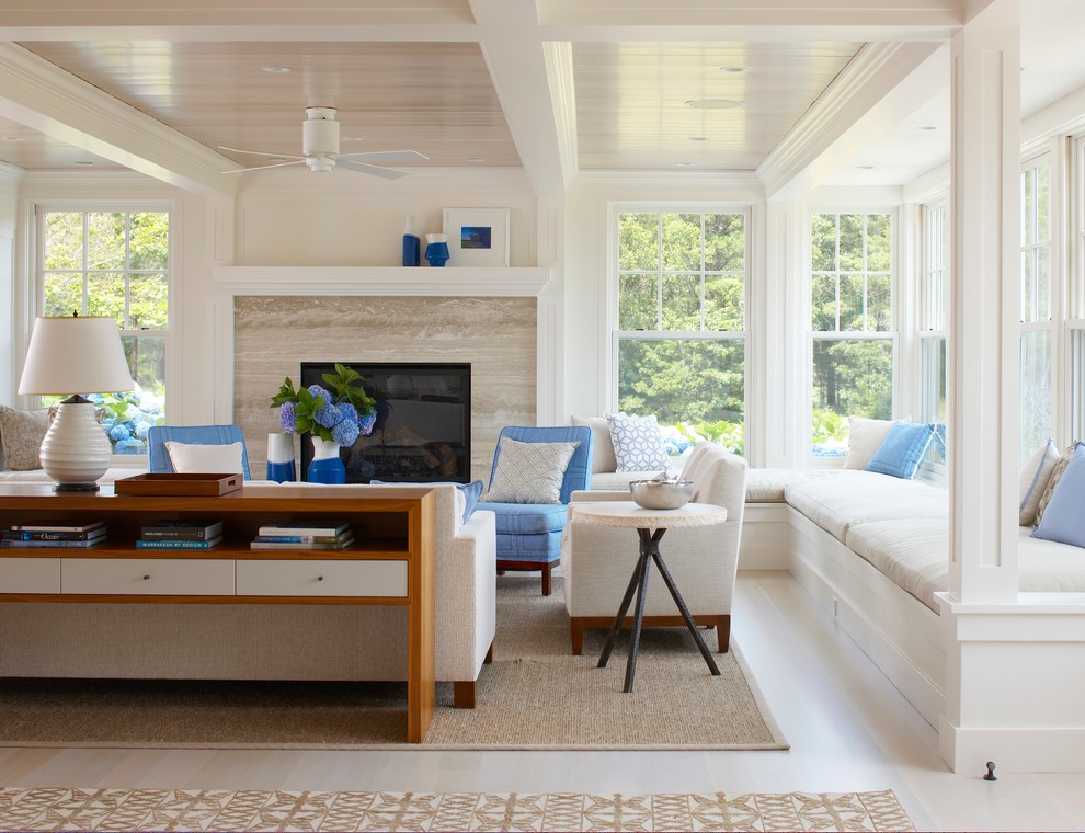 Photo of a large beach style formal open concept living room in Boston with white walls, light hardwood floors, a standard fireplace, a stone fireplace surround and beige floor.
