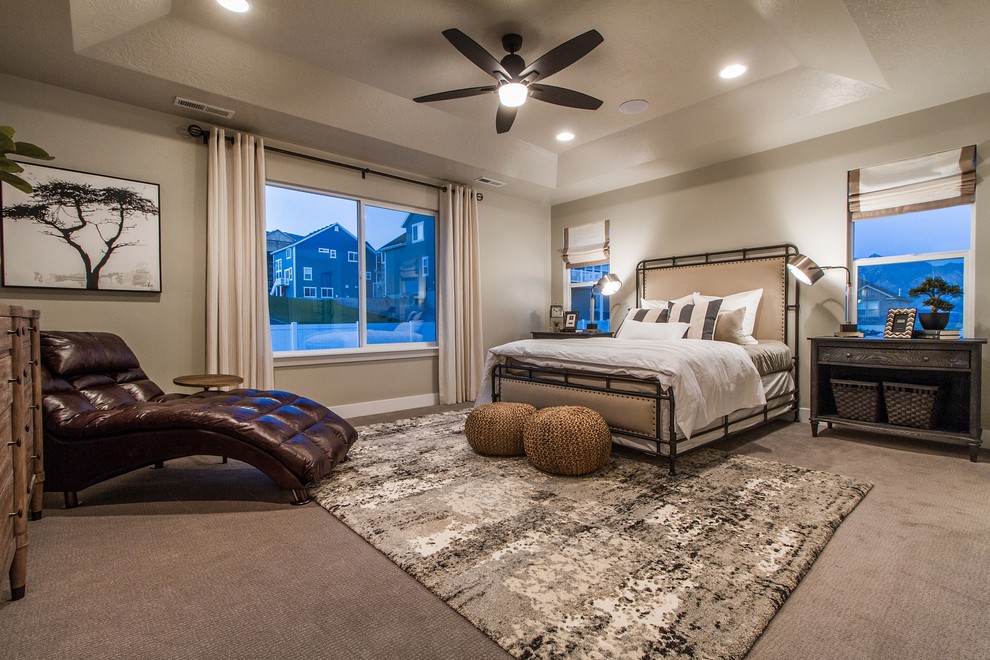 Photo of a large traditional master bedroom in Salt Lake City with beige walls, carpet, no fireplace and brown floor.