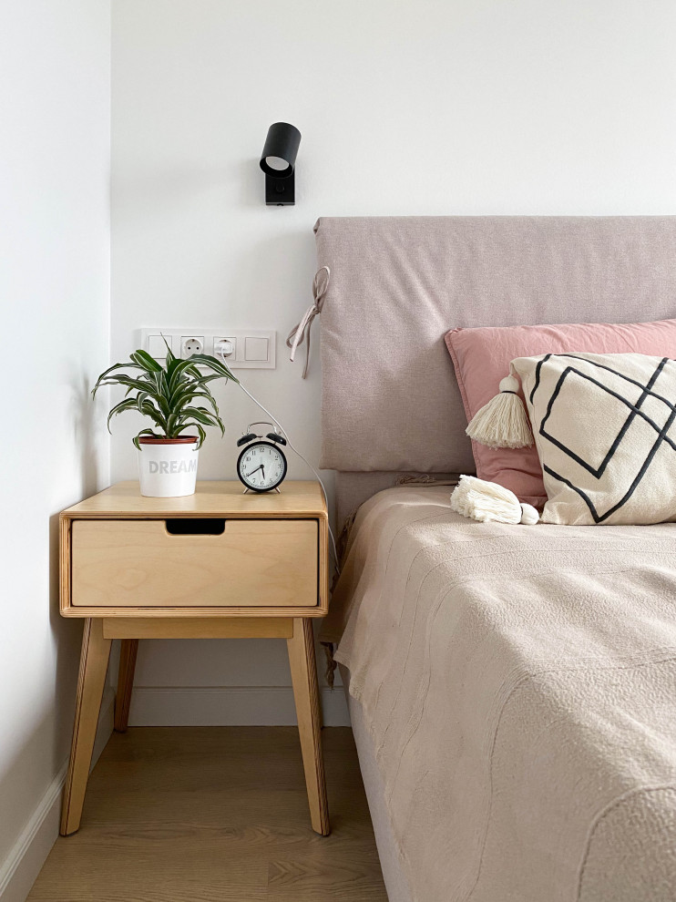 Inspiration for a medium sized scandi master bedroom in Moscow with white walls and laminate floors.