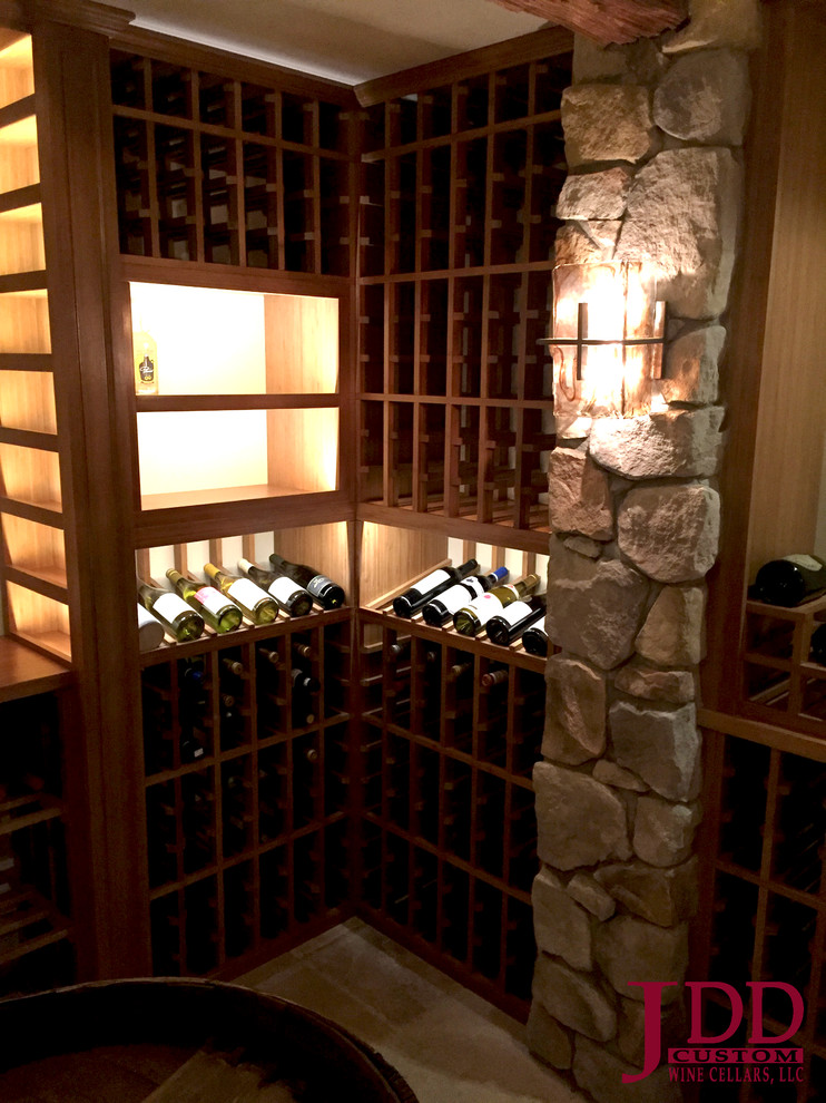 Photo of a large country wine cellar in San Diego with travertine floors and storage racks.
