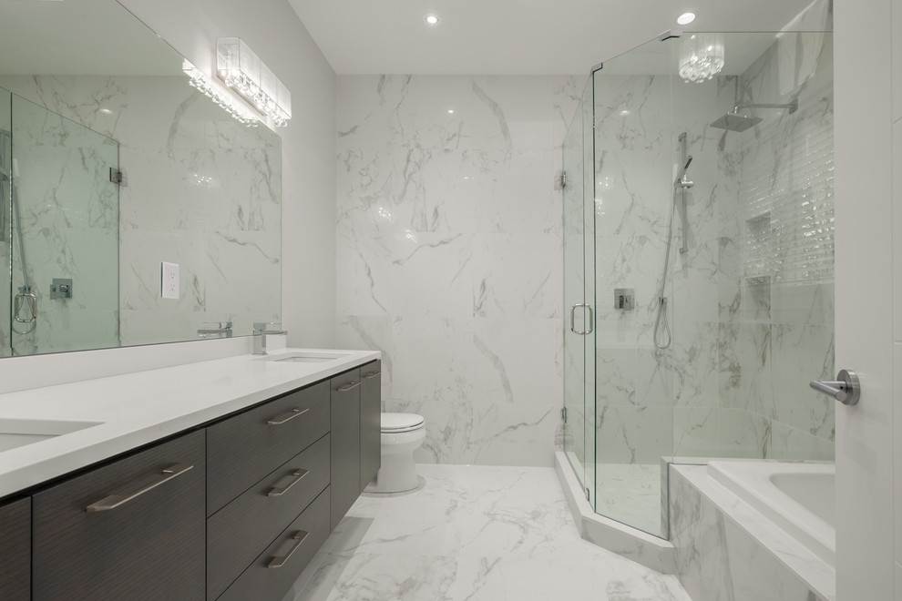 Example of a transitional master white tile corner shower design in Vancouver with flat-panel cabinets, dark wood cabinets, white walls, an undermount sink and quartz countertops