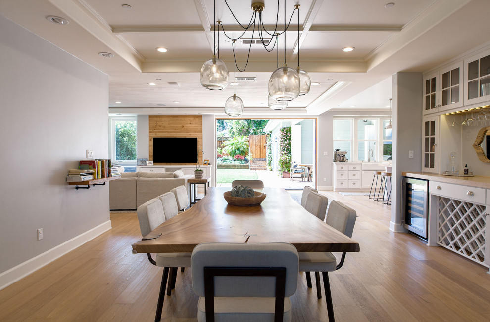 Large beach style open plan dining in San Diego with grey walls, medium hardwood floors and beige floor.