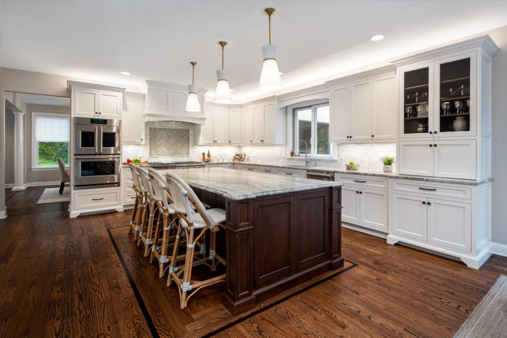 Large transitional l-shaped eat-in kitchen photo with stainless steel appliances, an island and gray countertops