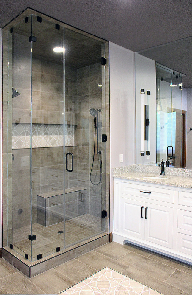 This is an example of a large traditional master bathroom in Other with raised-panel cabinets, white cabinets, a freestanding tub, a double shower, beige tile, porcelain tile, purple walls, marble floors, an undermount sink, engineered quartz benchtops, beige floor, a hinged shower door and beige benchtops.