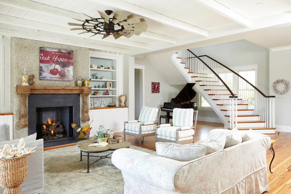 Inspiration for a beach style open concept living room in Other with a music area, grey walls and a standard fireplace.