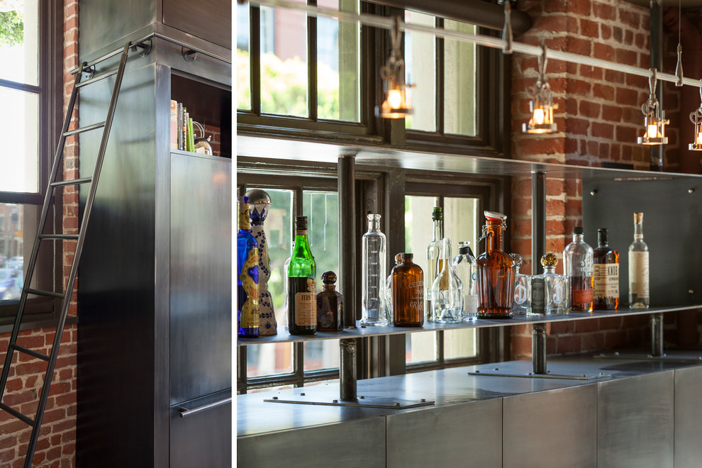 This is an example of a mid-sized industrial single-wall home bar in San Francisco with flat-panel cabinets, marble benchtops and concrete floors.