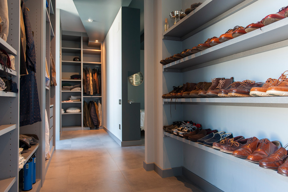 Photo of a mid-sized contemporary gender-neutral walk-in wardrobe in Other with open cabinets and ceramic floors.