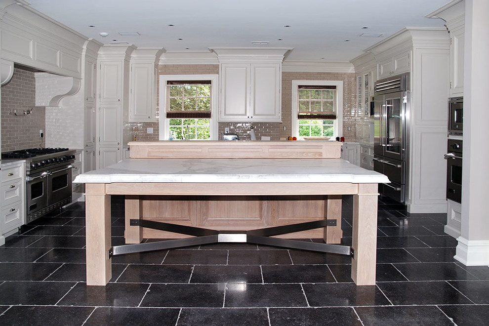 Inspiration for a large transitional u-shaped black floor eat-in kitchen remodel with an island, an undermount sink, recessed-panel cabinets, white cabinets and stainless steel appliances