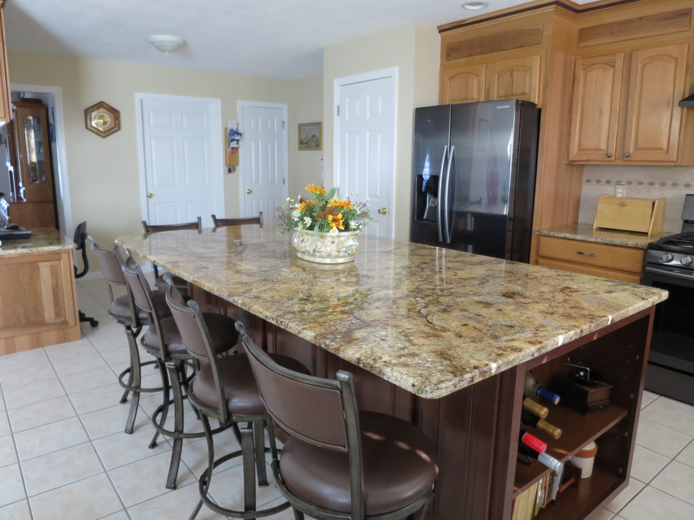 Mid-sized transitional u-shaped ceramic tile and white floor eat-in kitchen photo in Bridgeport with a double-bowl sink, raised-panel cabinets, light wood cabinets, granite countertops, white backsplash, subway tile backsplash, stainless steel appliances and an island