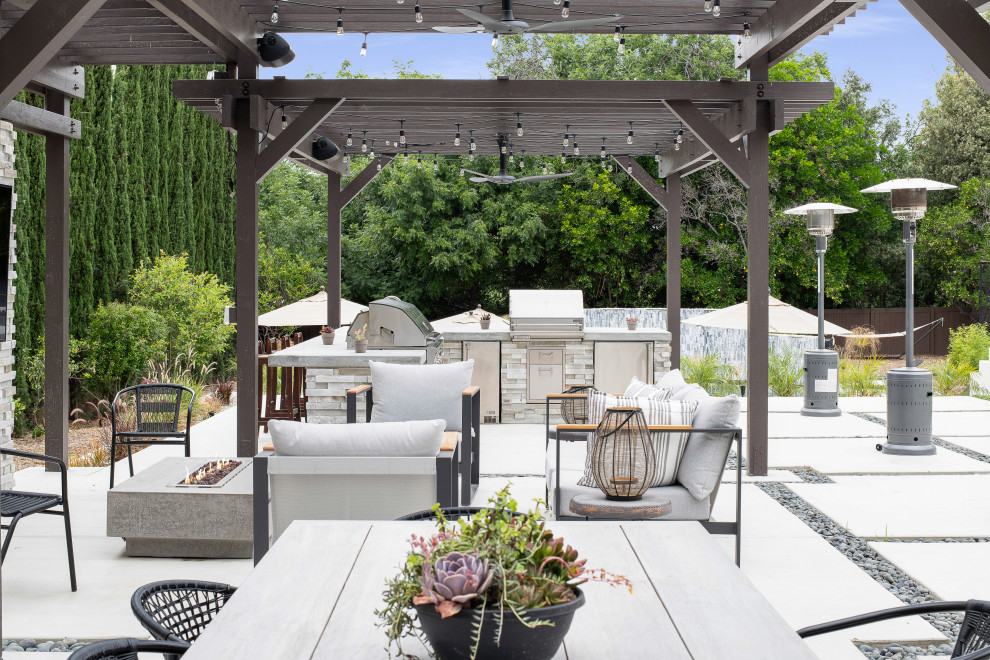 Transitional patio in Orange County with concrete slab and a pergola.