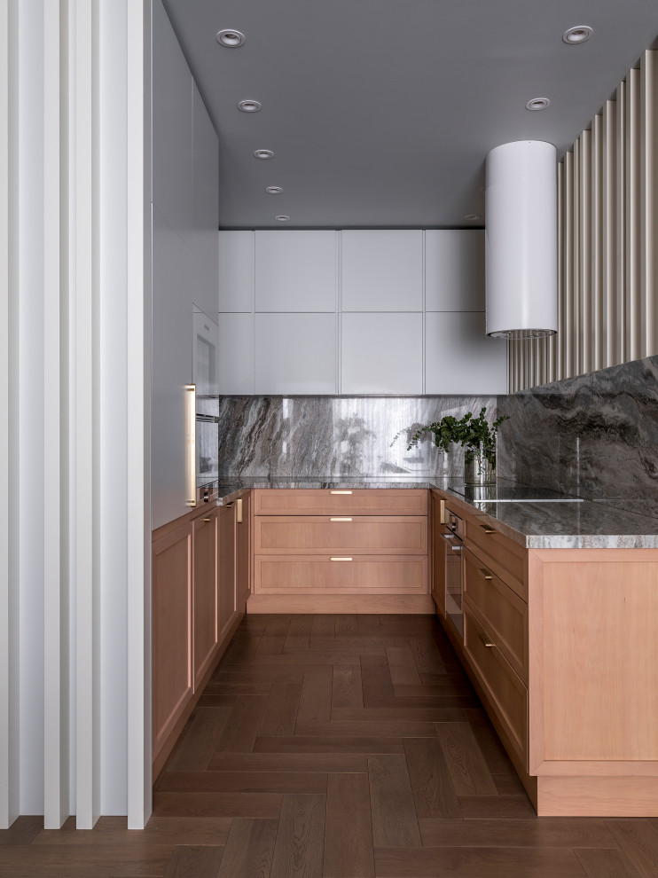 Mid-sized contemporary u-shaped kitchen in Moscow with shaker cabinets, grey cabinets, marble benchtops, grey splashback, marble splashback, medium hardwood floors and grey benchtop.