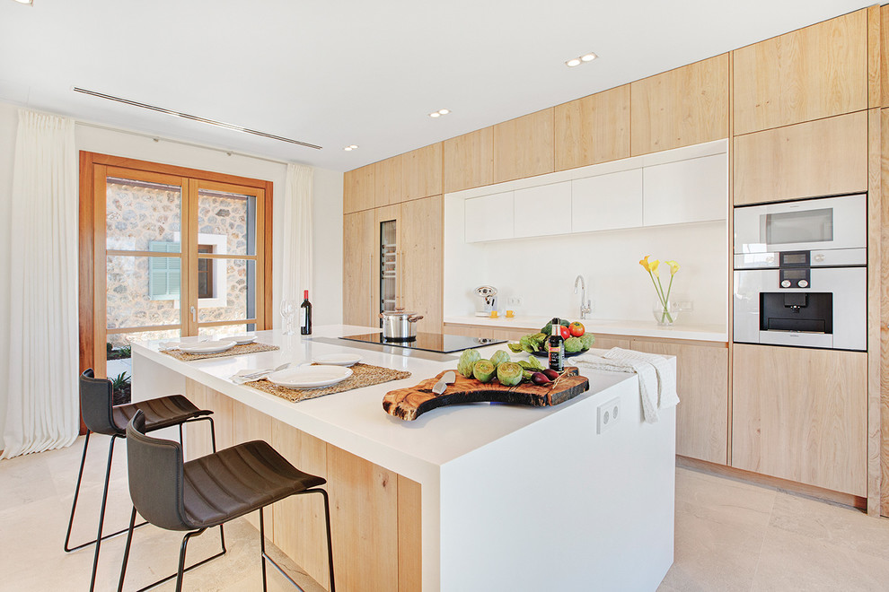 This is an example of a mid-sized contemporary single-wall kitchen in Palma de Mallorca with flat-panel cabinets, medium wood cabinets, white splashback, stainless steel appliances, with island and beige floor.
