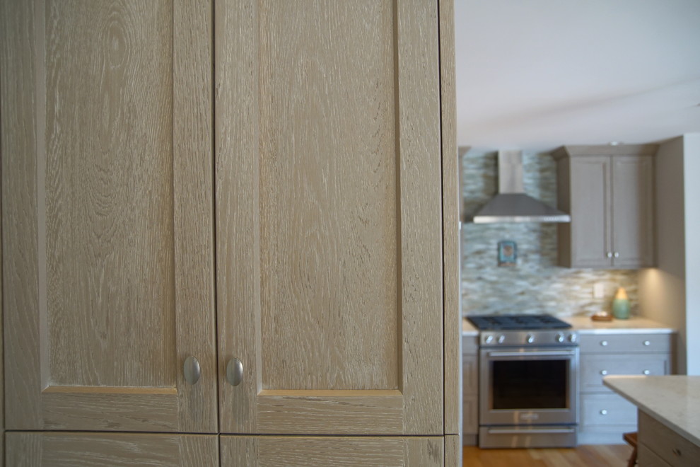 Inspiration for a mid-sized transitional l-shaped medium tone wood floor and beige floor eat-in kitchen remodel with an undermount sink, beaded inset cabinets, distressed cabinets, marble countertops, gray backsplash, ceramic backsplash, stainless steel appliances, an island and white countertops